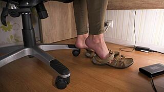 sneaky voyeur spies on natural feet in worn sandals under desk