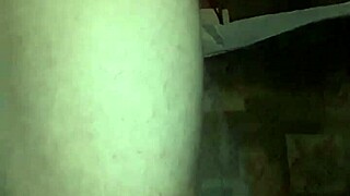 Young gay man in lingerie enjoys solo play with a dildo in a casual setting.