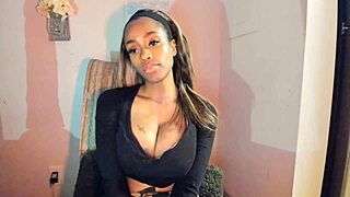 this tattooed ebony milf is playing with her big tits and pussy