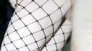 Slender girlfriend in skirt and stockings stands with friend at home