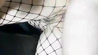 Slender girlfriend in skirt and stockings stands with friend at home