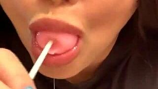Marcy Diamond is enjoying a lollipop with lots of spit in a fun, messy way