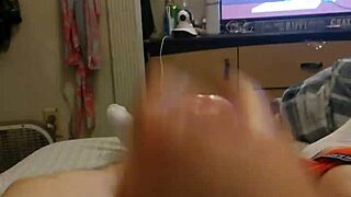 The sexy redhead gives a handjob to her best friend's big cock, ending in a facial.