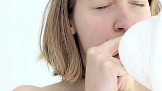 Hey there, watch this young looner babe blow and pop her first balloon!