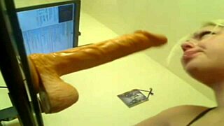 blonde woman deep throats a huge dildo until she cums