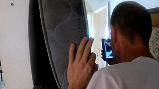 White-haired person watches boat owner's house from afar at party.