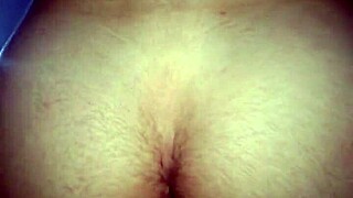 The guy sits on the macho man's dick.