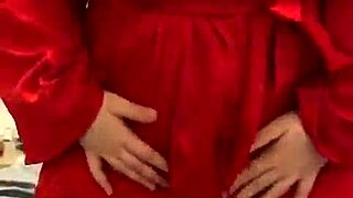 brunette in red lingerie indulges in solo play