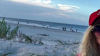 Public pussy play on hot beach attracts curious onlookers