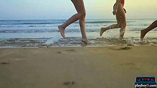 four lesbian girlfriends relax on the beach with striptease fun