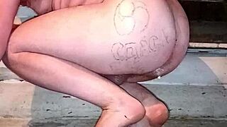 gay man with painted lips stuffs butter up his tattooed ass