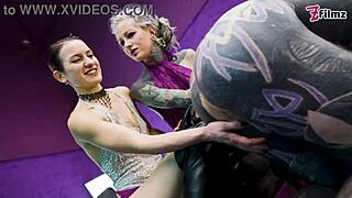  Tattooed sub gets roughed up and pegged hard by two dominas