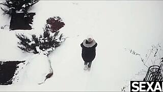 cute couple warms up with intimate touches on snowy day