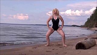 blonde babe in costume charges at sea during workout