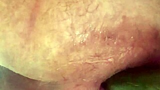 A gay stud enjoys close-up anal play with big dildos, leading to lactation