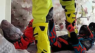 Motocross gay in biker costumes, boots treading on the action.