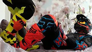 Motocross gay in biker costumes, boots treading on the action.