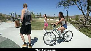 Two horny Asian cuties dominate guy in wild group action.