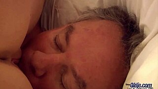 A hot blonde woman interacts with an older man in a suggestive setting and handles the outcome