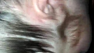 An interracial scene featuring moaning and deepthroat actions in a casual setting.