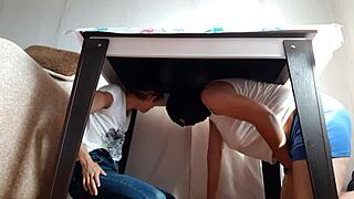 two brunette lesbians hide under the desk in jeans and miniskirts to masturbate passionately