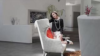 The beautiful brunette girl lies on the bed fingering her shaved pussy intensely.