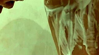 Milf gets naked in the shower, revealing big tits while bathing sensually in private moment.