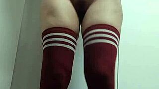 This cheeky nerdy girl tried on slutty tops in the change room, going topless and nude with thigh high socks sans panties.