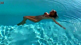 gorgeous monika fox with big tits and pierced nipples swims naked in pool at beautiful outdoor place