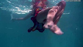 Redhead babe Nikita Vodorezova strips naked quickly in underwater pool scene