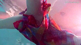 Redhead babe Nikita Vodorezova strips naked quickly in underwater pool scene