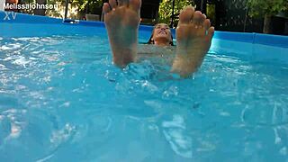 melissa the mermaid shows brown eyes and tattoo by the pool in milf solo scene