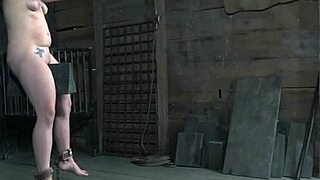 Bound BDSM sub experiments with fire in intense session