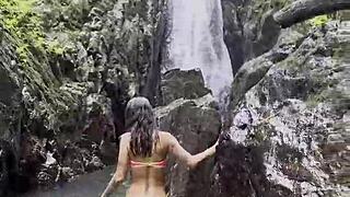 Monika Fox Walks Through Jungle In Pink Top Yellow Shorts Showing Big Tits Pierced Nipples Naked