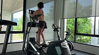 brunette fitness babe with muscular body and small tits poses in gym workout photoshoot.